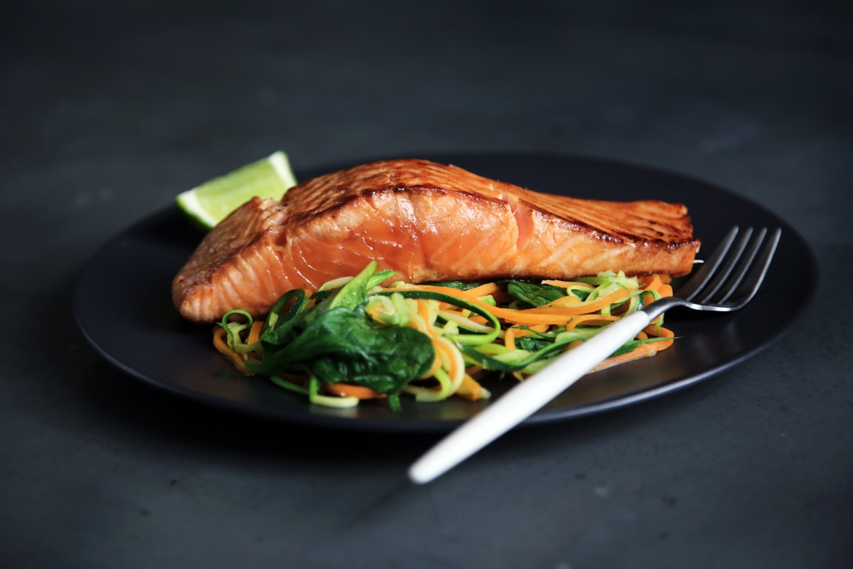 Seared Gulf fish plated on dark slate